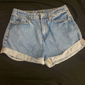 Jean shorts, on the back says “Happy”.